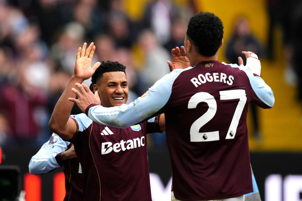 Aston Villa's Ollie Watkins (left) celebrates scoring their side's second goal of the game with teammate Morgan Rogers, during the English Premier League soccer match between Aston Villa and West Ham United, in Birmingham, England, Sunday, March 22, 2026. (Nick Potts/PA via AP)