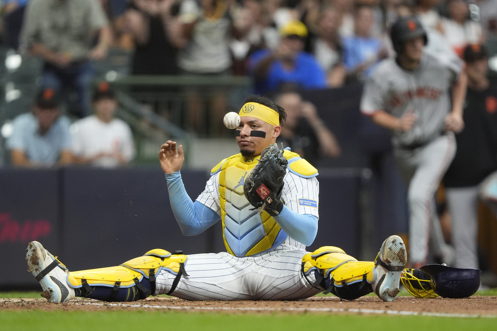 Milwaukee Brewers' William Contreras reacts after tagging San Francisco Giants' Luis Matos out at home plate during the sixth inning of a baseball game Saturday, Aug. 23, 2025, in Milwaukee. (AP Photo/Aaron Gash)