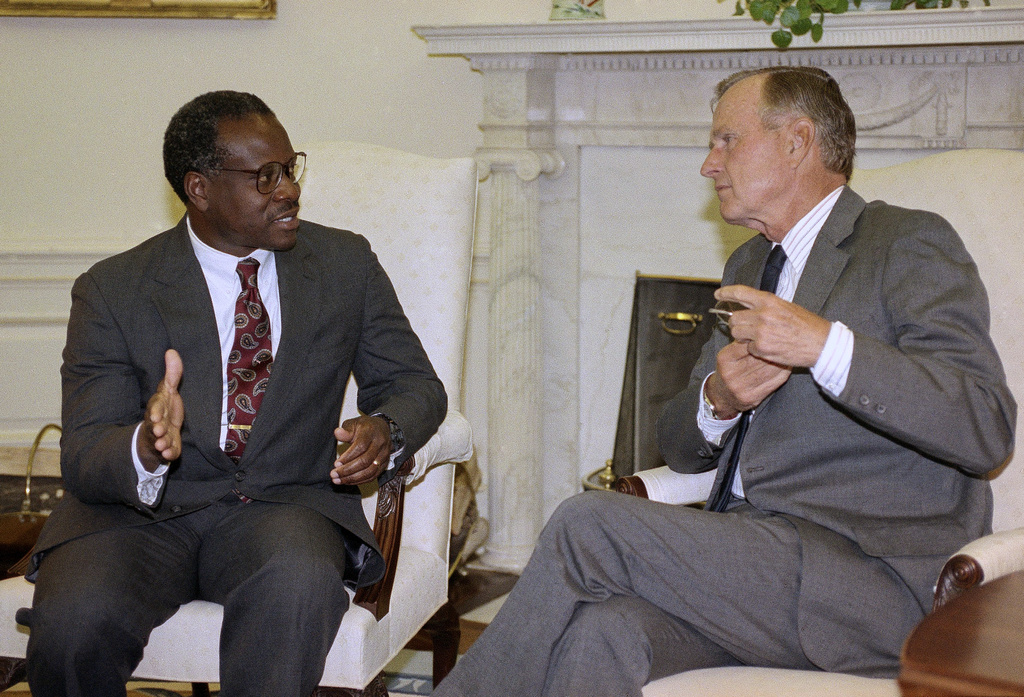 FILE - President George H.W. Bush and Supreme Court nominee Clarence Thomas hold a private meeting in the Oval Office at the White House in Washington, Sept. 6, 1991. (AP Photo/Greg Gibson, File)