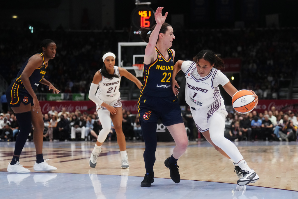 Toronto Tempo's Teonni Key, right, drives as Indiana Fever's Caitlin Clark (22) defends during the first half of a WNBA basketball game in Toronto, Friday, Sept. 18, 2026. (Nathan Denette/The Canadian Press via AP)