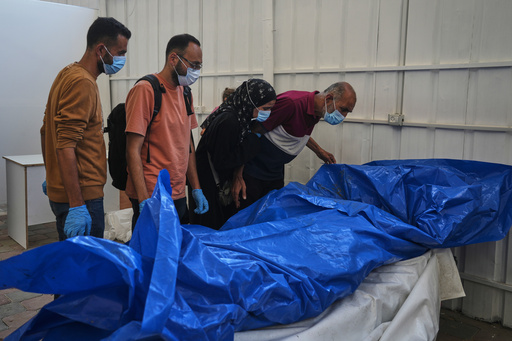 A medical team and relatives examine the bodies of Palestinians held by Israel during the war, as part of the identification process at Nasser Hospital in Khan Younis, southern Gaza Strip, Tuesday, Oct. 21, 2025. (AP Photo/Jehad Alshrafi) A medical team and relatives examine the bodies of Palestinians held by Israel during the war, as part of the identification process at Nasser Hospital in Khan Younis, southern Gaza Strip, Tuesday, Oct. 21, 2025. (AP Photo/Jehad Alshrafi)
