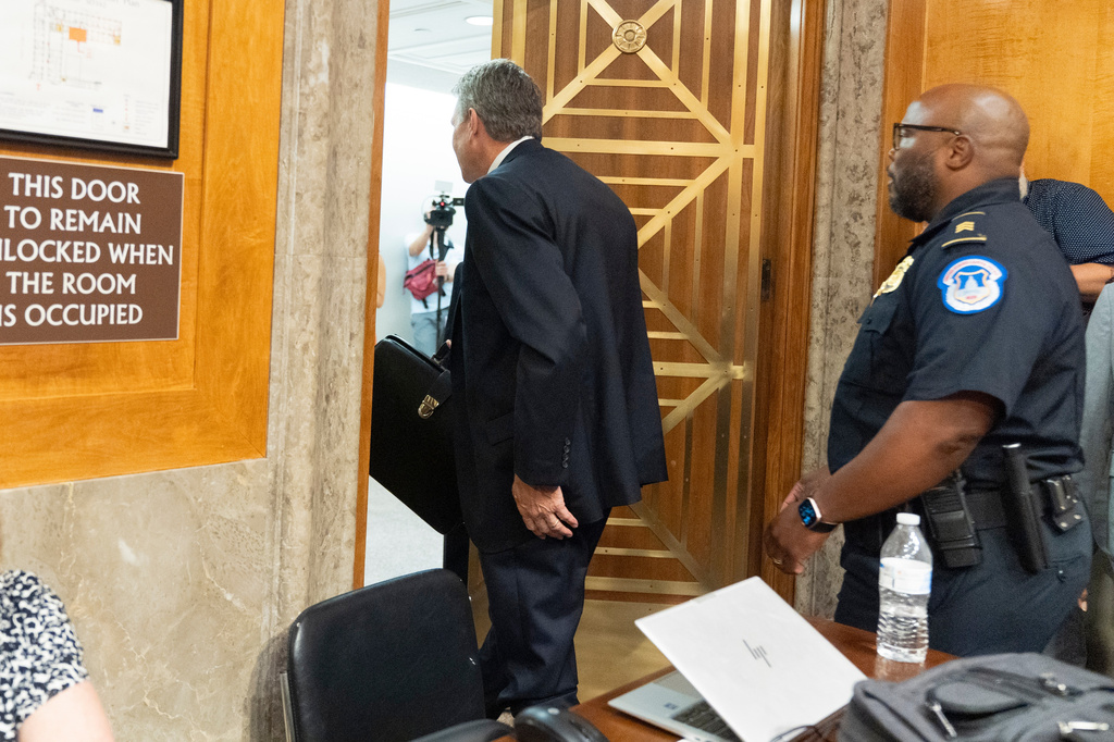 David Schertler, Dr. Anthony Fauci’s defense lawyer, is escorted out, as Fauci appears before the Senate Homeland Security and Governmental Affairs Committee at the Capitol, Wednesday, July 29, 2026, in Washington. (AP Photo/Manuel Balce Ceneta)