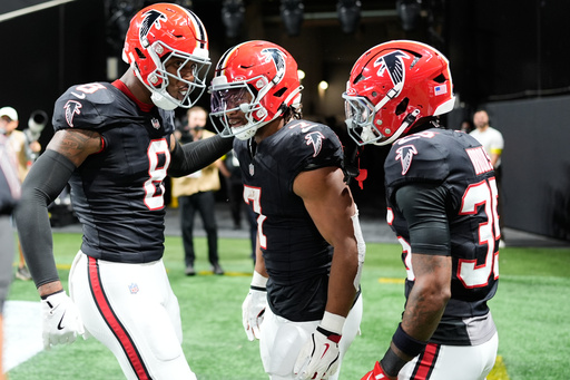 Atlanta Falcons running back Bijan Robinson (7) celebrates his rushing touchdown with tight end Kyle Pitts (8) and cornerback Natrone Brooks (35) during the first half of an NFL football game against the Buffalo Bills, Monday, Oct. 13, 2025, in Atlanta. (AP Photo/Mike Stewart) Atlanta Falcons running back Bijan Robinson (7) celebrates his rushing touchdown with tight end Kyle Pitts (8) and cornerback Natrone Brooks (35) during the first half of an NFL football game against the Buffalo Bills, Monday, Oct. 13, 2025, in Atlanta. (AP Photo/Mike Stewart)