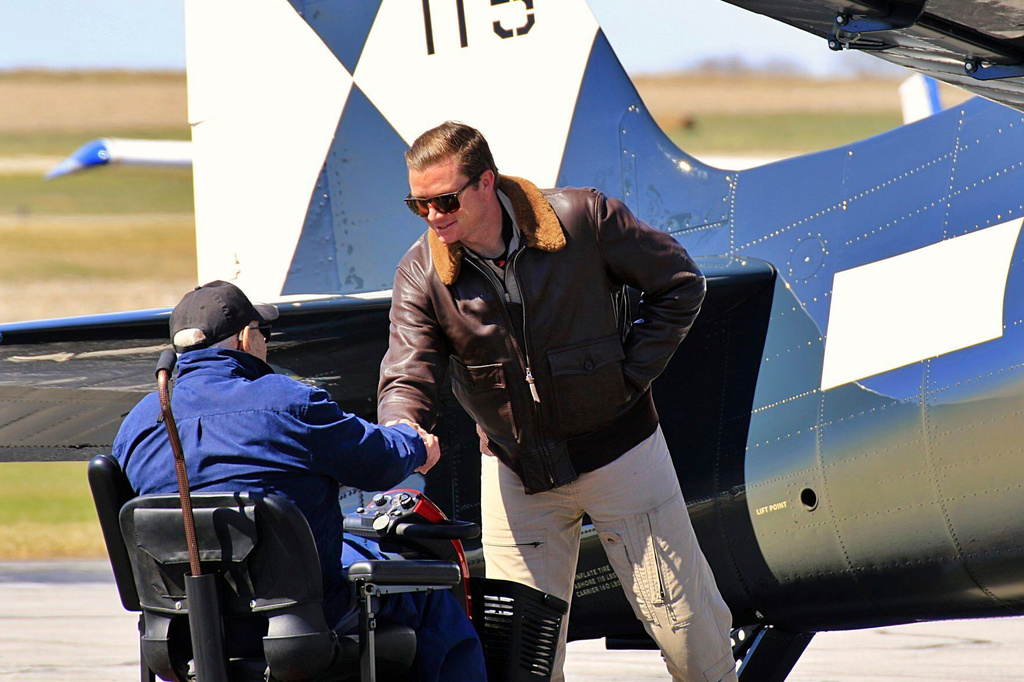 Donald McPherson, left, greets the pilot of a restored Hellcat, Steve Hinton Jr., at the Beatrice Municipal Airport in March 2021. (Dave Lyons/Beatrice Daily Sun via AP)