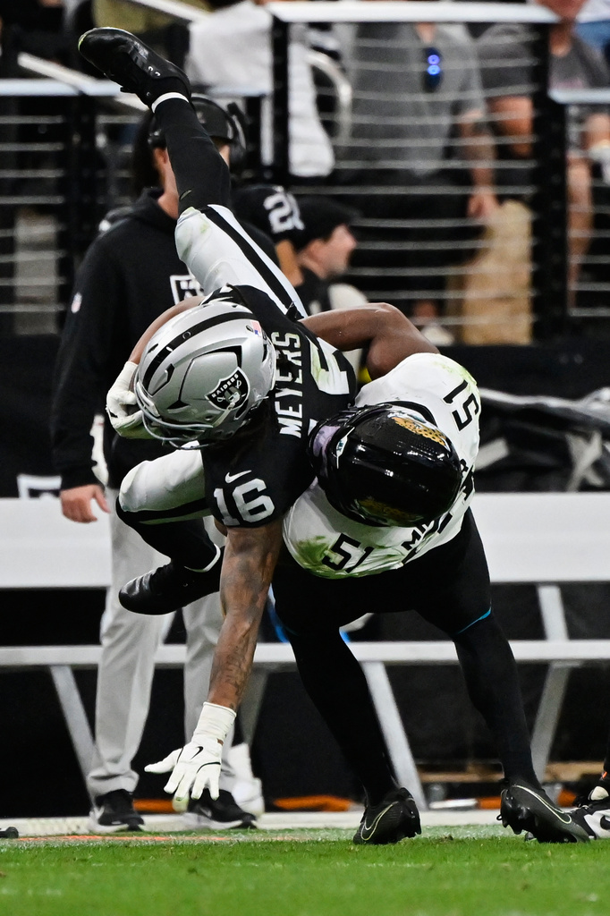 Jacksonville Jaguars linebacker Ventrell Miller (51) tackles Las Vegas Raiders wide receiver Jakobi Meyers (16) during the second half of an NFL football game, Sunday, Nov. 2, 2025, in Las Vegas. (AP Photo/David Becker)