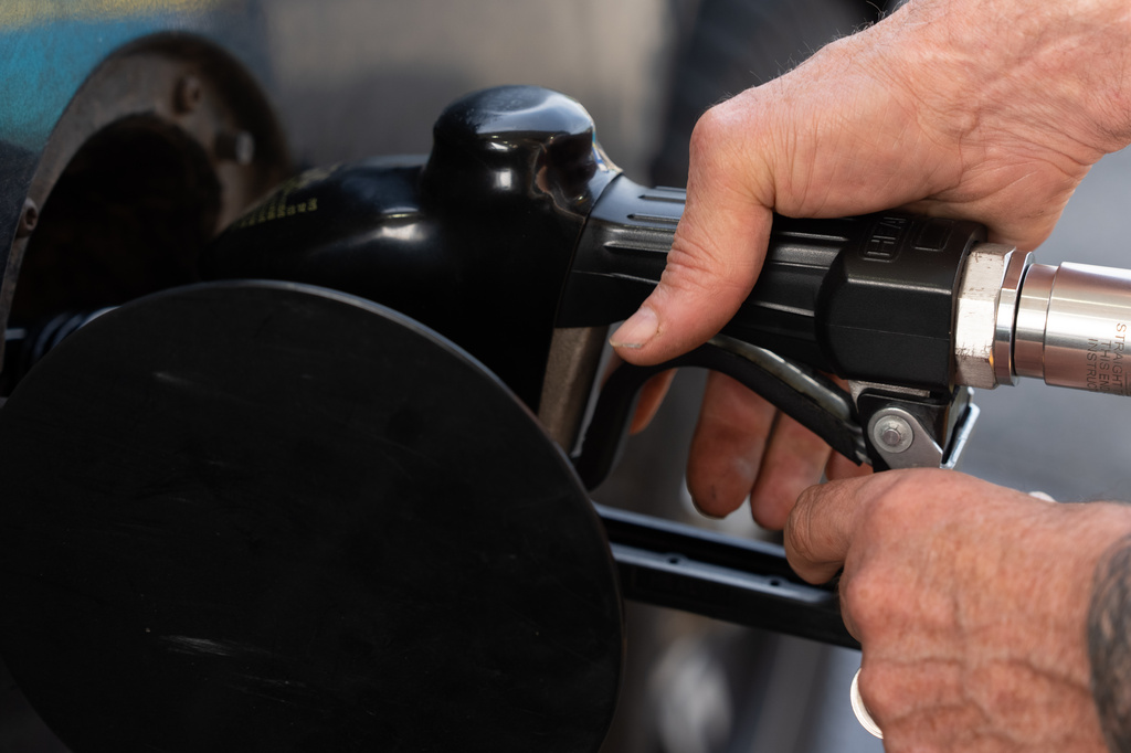 FILE - A person secures the fuel nozzel while filling up their tank at a gas station on Tuesday, May 12, 2026, in Portland, Ore. (AP Photo/Jenny Kane, File)