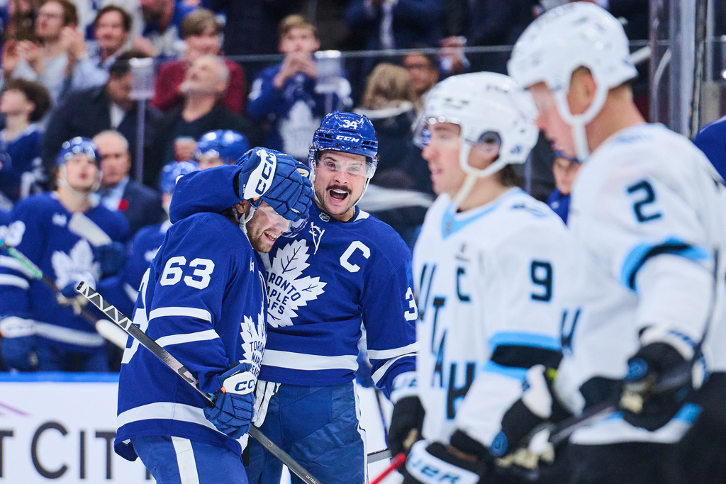 Toronto Maple Leafs' Auston Matthews (34) celebrates with teammate Matias Maccelli (63) after scoring against the Utah Mammothsduring second period NHL hockey action in Toronto, on Wednesday, Nov. 5, 2025. (Sammy Kogan/The Canadian Press via AP)