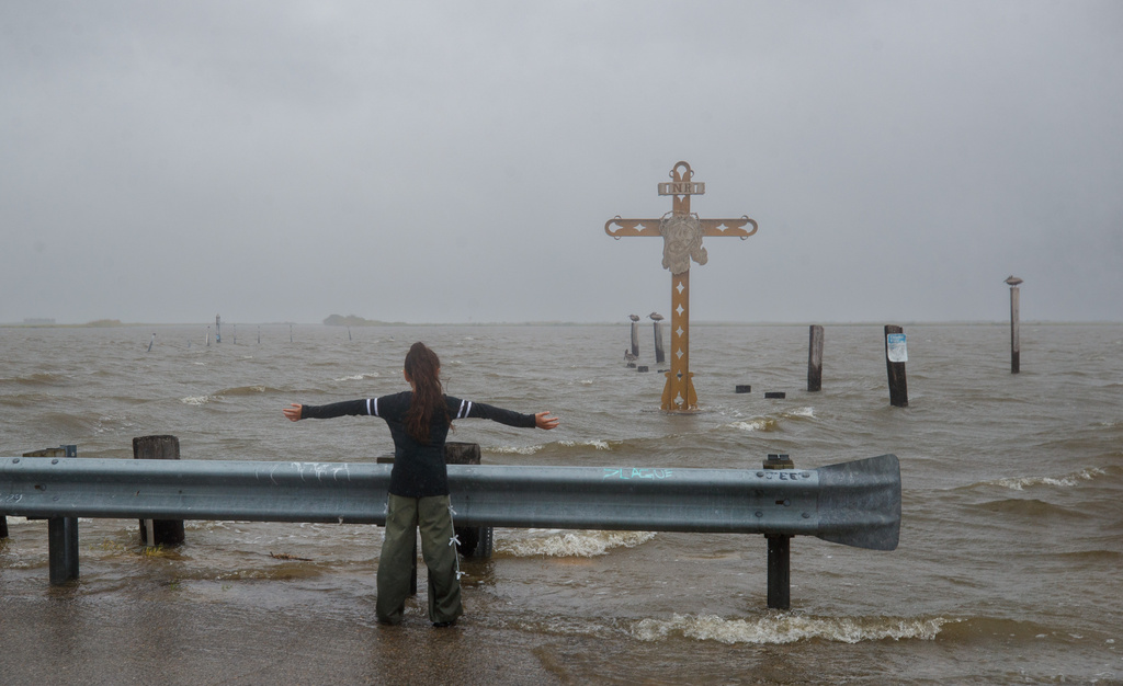 Grettel Badillo catches the wind from Tropical Storm Bertha at the Hurricane Katrina Memorial in Shell Beach, La., Wednesday, July 22, 2026. (David Grunfeld/The Times-Picayune/The New Orleans Advocate via AP)
