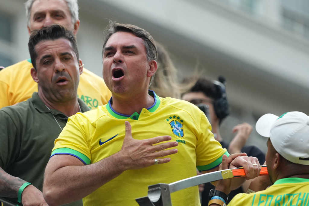 Sen. Flavio Bolsonaro, son of former President Jair Bolsonaro and a candidate in Brazil's October presidential election, gestures to supporters during a protest against President Luiz Inacio Lula da Silva in Sao Paulo, Sunday, March 1, 2026. (AP Photo/Andre Penner)