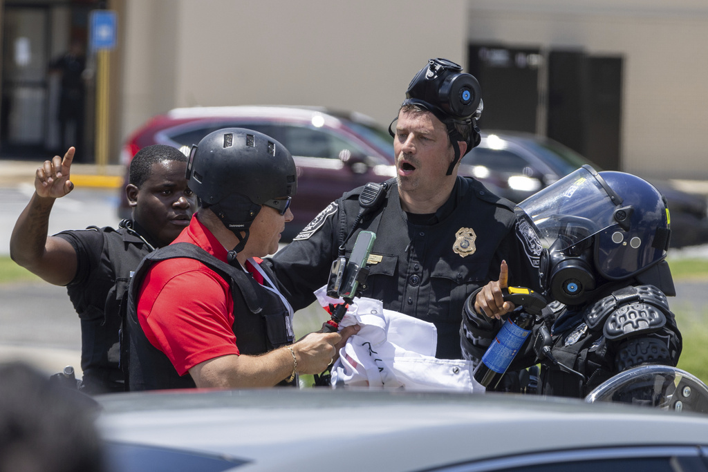 Police tell Spanish-language reporter Mario Guevara to move back during a protest on ICE raids and deportation arrests on Chamblee Tucker Road in Atlanta on Saturday, June 14, 2025. (Arvin Temkar/Atlanta Journal-Constitution via AP)