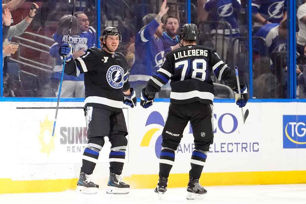Tampa Bay Lightning defenseman Charle-Edouard D'Astous (51) celebrates his goal against the Boston Bruins with defenseman Emil Lilleberg (78) during the third period of an NHL hockey game Saturday, April 4, 2026, in Tampa, Fla. (AP Photo/Chris O'Meara)
