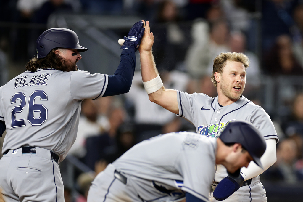 Tampa Bay Rays' Taylor Walls celebrates scoring with Ryan Vilade (26) in the seventh inning during the second baseball game of a doubleheader against the New York Yankees, Tuesday, Sept. 22, 2026, in New York. (AP Photo/Adam Hunger)