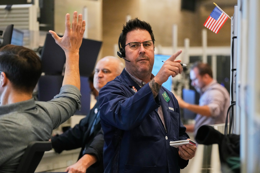 Options trader Andrew Longer, right, works on the floor of the New York Stock Exchange, Wednesday, Oct. 15, 2025. (AP Photo/Richard Drew)