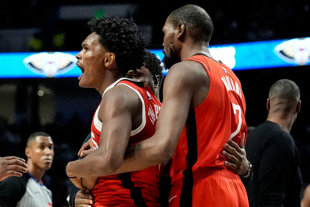 Houston Rockets' Amen Thompson (1) is held by Kevin Durant (7) after a scuffle on the court against New Orleans Pelicans' Jose Alvarado during the first half of an NBA preseason basketball game, Tuesday, Oct. 14, 2025, in Birmingham, Ala. (AP Photo/Mike Stewart)