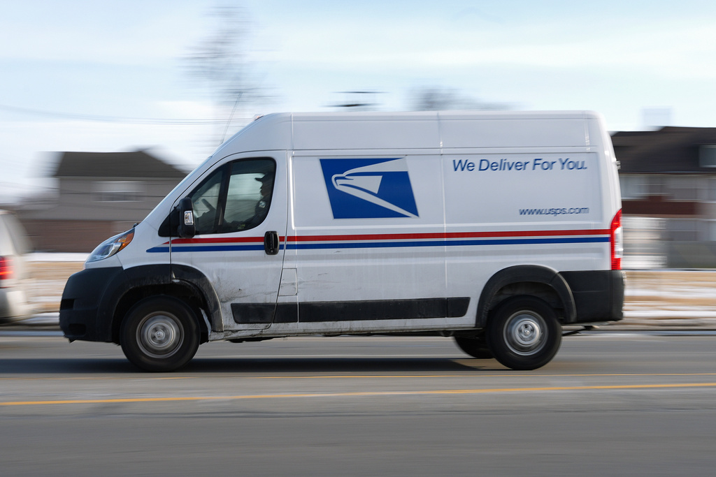 FILE - A United States Postal Service truck drives through Detroit, Feb. 24, 2025. (AP Photo/Paul Sancya, File)