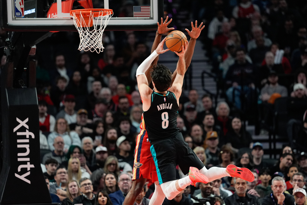 Portland Trail Blazers forward Deni Avdija (8) goes to the basket as Portland Trail Blazers new owner Tom Dundon, second from right, watches during the first half of an NBA basketball game against the New Orleans Pelicans, Thursday, April 2, 2026, in Portland, Ore. (AP Photo/Jenny Kane)