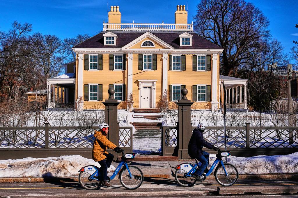 Cyclists pass the Longfellow House, which was George Washington's headquarters during the Siege of Boston in the mid-1770's, Friday, Feb. 13, 2026, in Cambridge, Mass. (AP Photo/Charles Krupa)