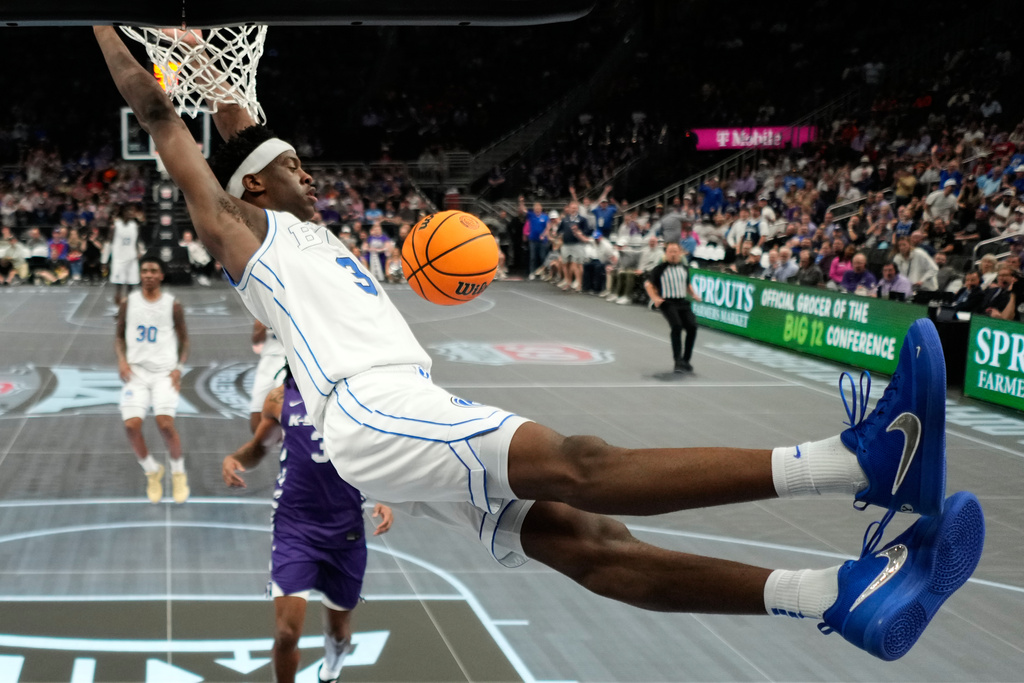 BYU forward AJ Dybantsa dunks the ball during the second half of an NCAA college basketball game against Kansas State at the Big 12 Conference tournament Tuesday, March 10, 2026, in Kansas City, Mo. (AP Photo/Charlie Riedel)