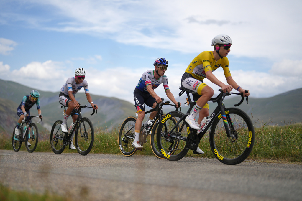 Slovenia's Tadej Pogacar climbs the Sarenne pass ahead of Belgium's Remco Evenepoel, center, and Mexico's Isaac Del Toro, left, during the twentieth stage of the Tour de France cycling race with start in Le Bourg d'Oisans and finish in Alpe d'huez, France, Saturday, July 25, 2026. (AP Photo/Thibault Camus)