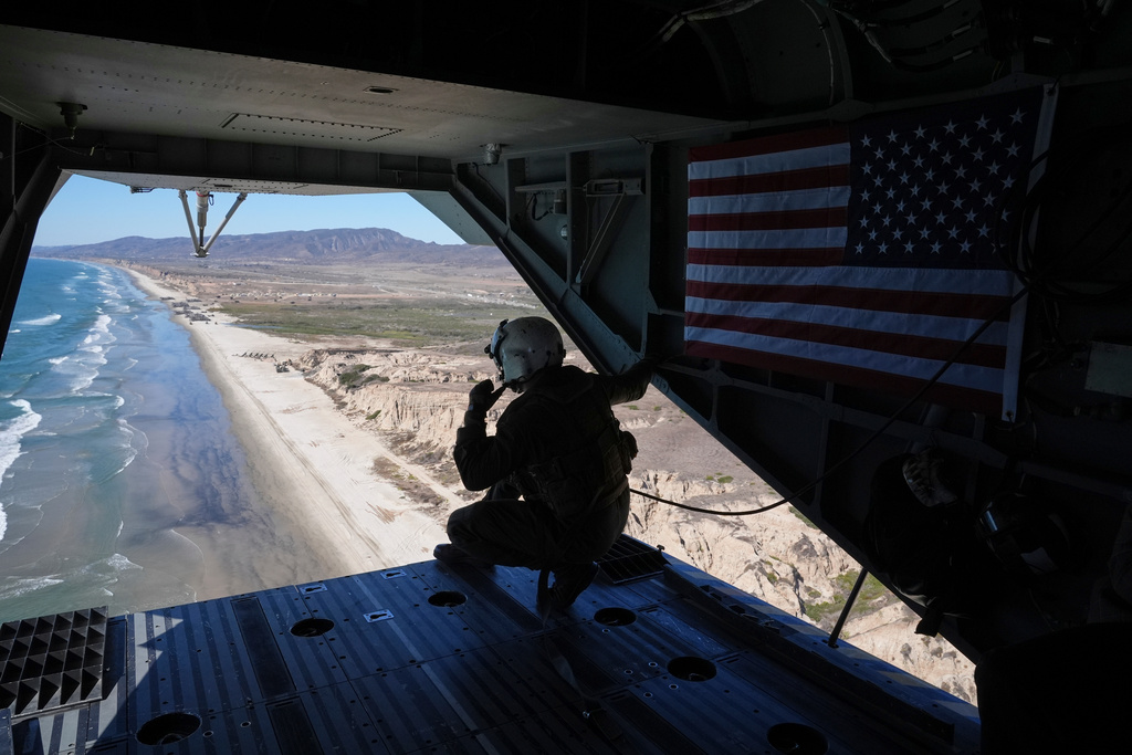 A Marines is pictured in a helicopter during a demonstration to mark the upcoming Marine Corps' 250th anniversary Saturday, Oct 18, 2025, on Marine Corps Base Camp Pendleton in Camp Pendleton, Calif. (AP Photo/Gregory Bull)