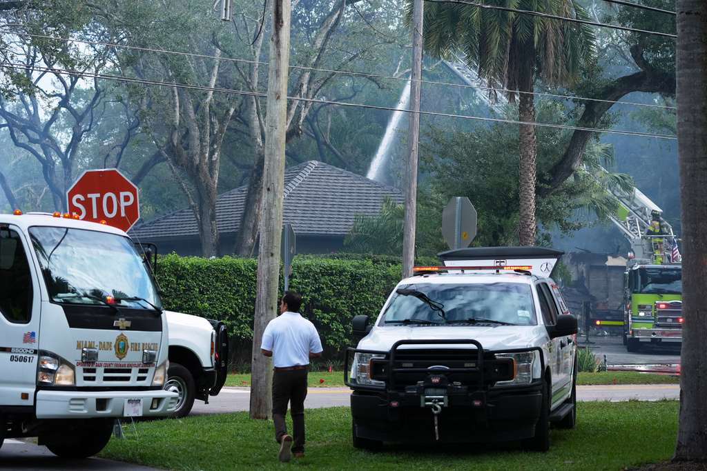 Firefighters work to extinguish the remains of a fire at a home owned by Miami Heat basketball coach Erik Spoelstra, Thursday, Nov. 6, 2025, in Miami. (AP Photo/Rebecca Blackwell)