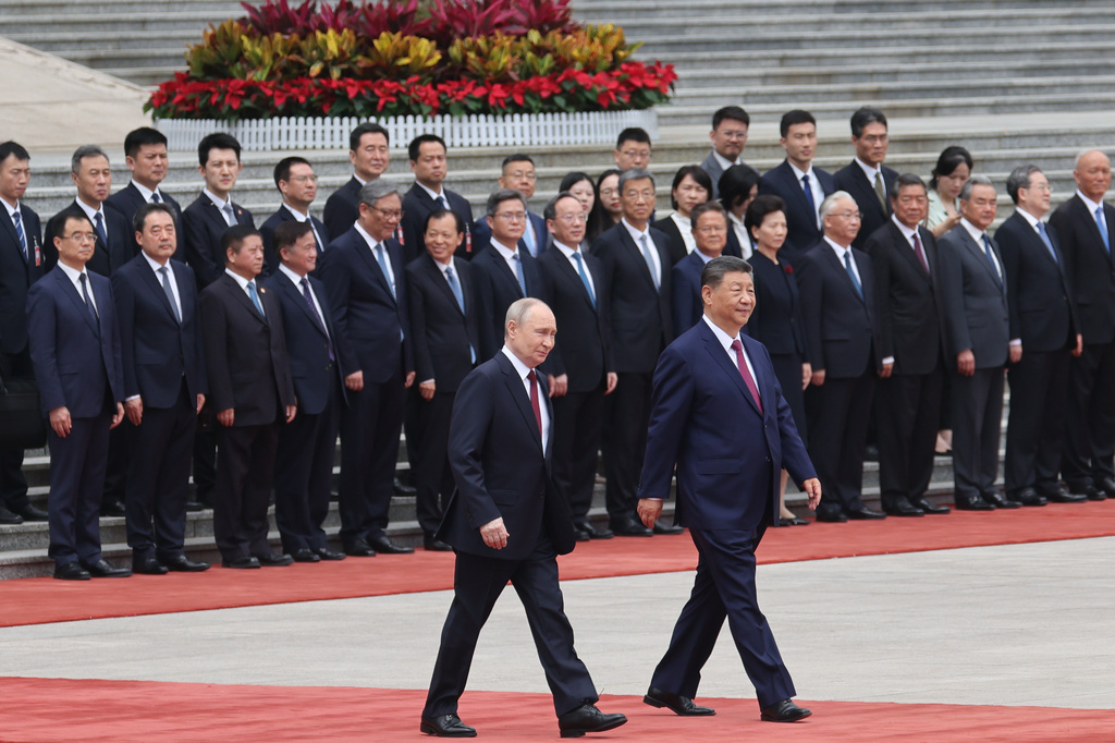 Russian President Vladimir Putin, left, walks with Chinese President Xi Jinping during a welcoming ceremony at the Great Hall of the People in Beijing Wednesday, May 20, 2026. (Maxim Shemetov/Pool Photo via AP)