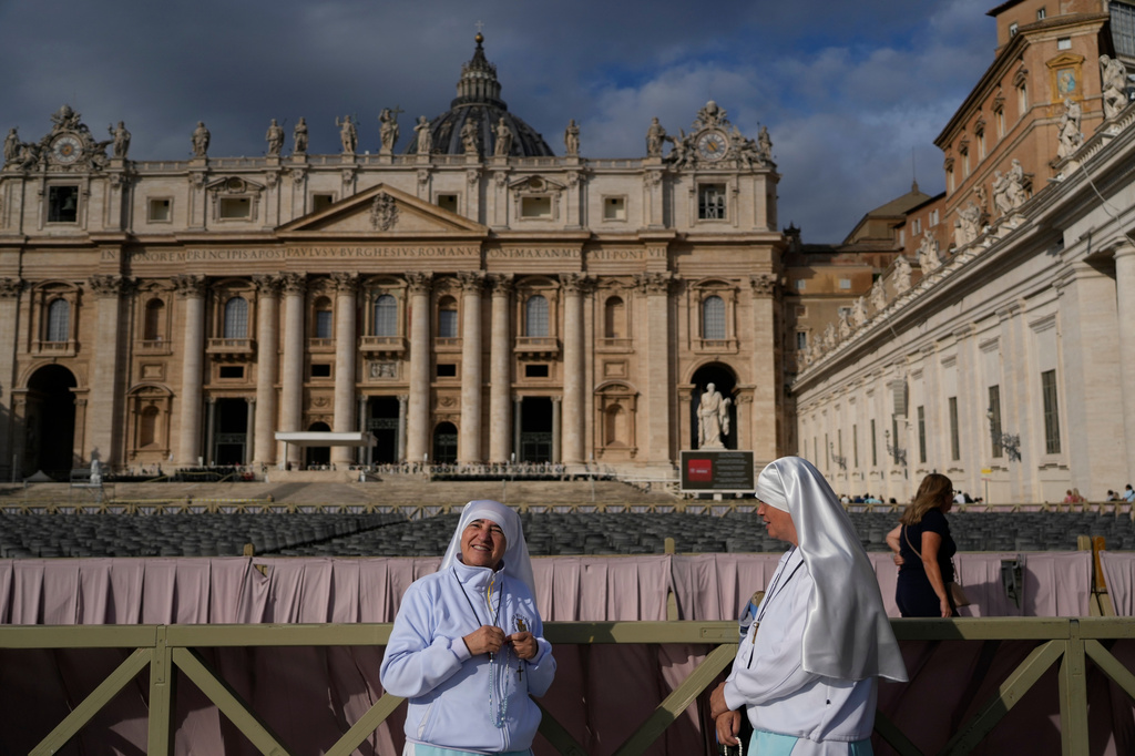 Two nuns arrive in St. Peter's Square at the Vatican for the traditional noon blessing after praying the Angelus with Pope Leo XIV, Sunday, Oct. 18, 2026, a day after he returned from the hospital, where he had lung cancer removed on Tuesday. (AP Photo/Gregorio Borgia)