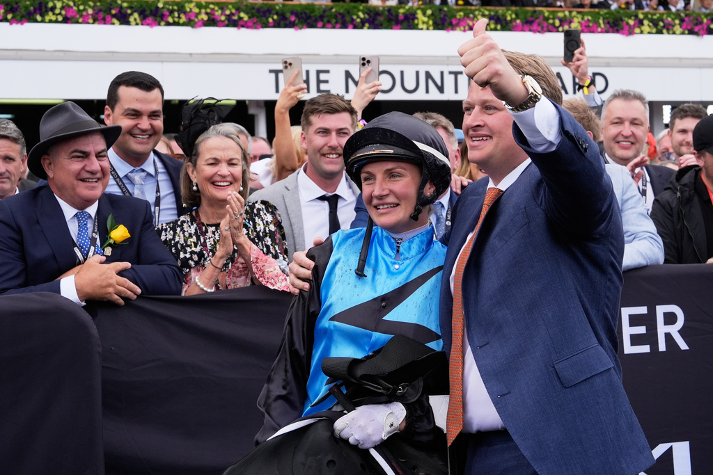 Trainer Calvin McEvoy and jockey Jamie Melham celebrate after Half Yours won the Melbourne Cup horse race in Melbourne, Australia, Tuesday, Nov. 4, 2025. (AP Photo/Asanka Brendon Ratnayake)