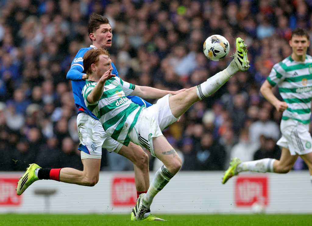Ranger's Ryan Naderi, left, and Celtic's Liam Scales, right, challenge for the ball during the Scotish Premiership match between Glasgow Rangers and Celtic Glasgow in Glasgow, Scotland, Sunday, March 1, 2026. (Steve Welsh/PA via AP)