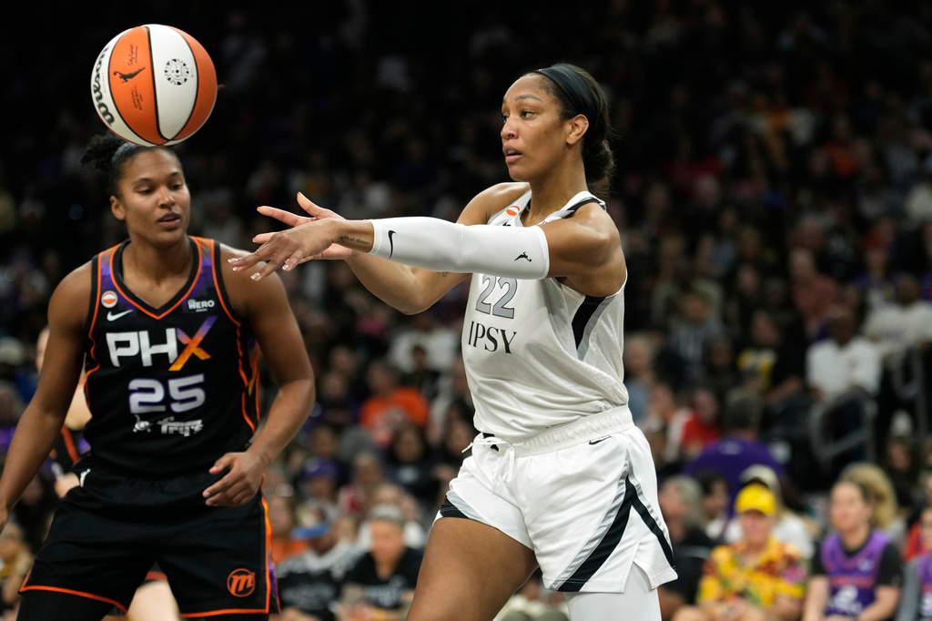 Las Vegas Aces center A'ja Wilson (22) gets off a pass against Phoenix Mercury forward Alyssa Thomas (25) during the first half of a WNBA basketball game, Thursday, Sept. 24, 2026, in Phoenix. (AP Photo/Ross D. Franklin)