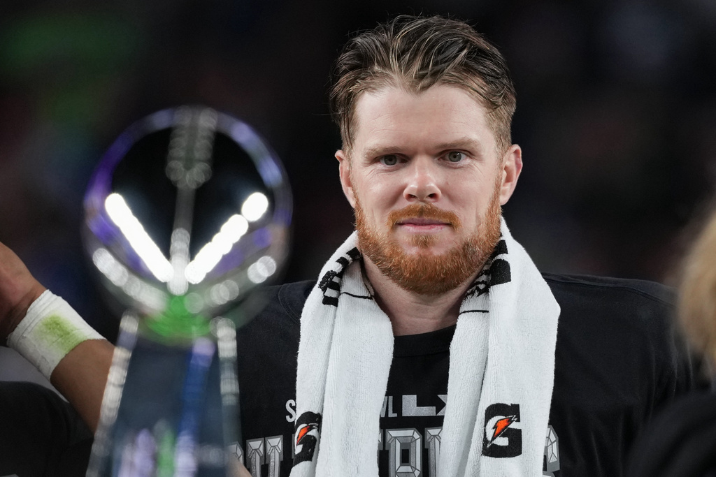 Seattle Seahawks quarterback Sam Darnold eyes the Lombardi Trophy after a win over the New England Patriots in the NFL Super Bowl 60 football game Sunday, Feb. 8, 2026, in Santa Clara, Calif. (AP Photo/Matt Slocum)