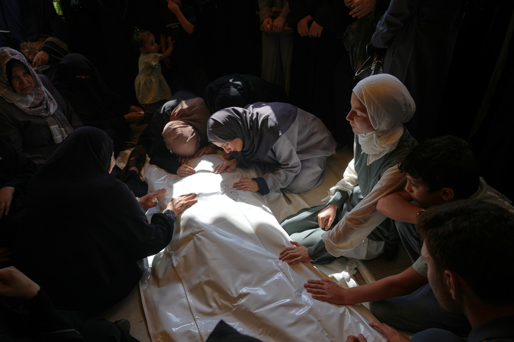 Palestinian women mourn over the body of Muhammad Yazouri, who was killed in an Israeli airstrike Thursday night, ahead of his funeral in Khan Younis, southern Gaza Strip, Friday, Sept.11, 2026. (AP Photo/Jehad Alshrafi)