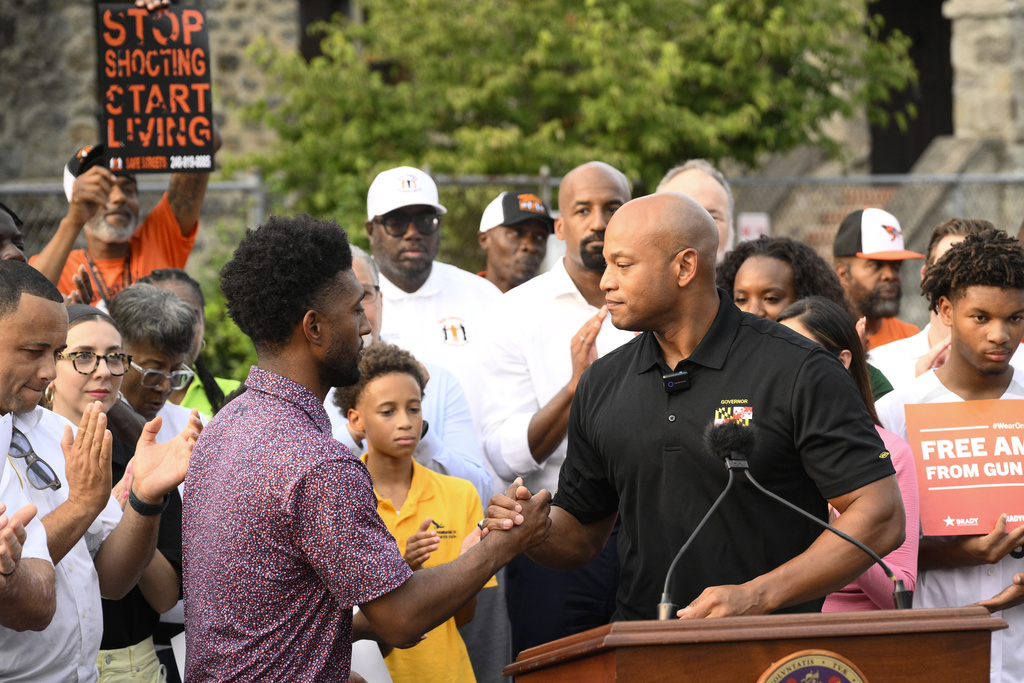 Maryland Gov. Wes Moore, right, shakes hands with Baltimore mayor Brandon Scott, left, Friday, Sept. 5, 2025, in Baltimore. (AP Photo/Nick Wass)