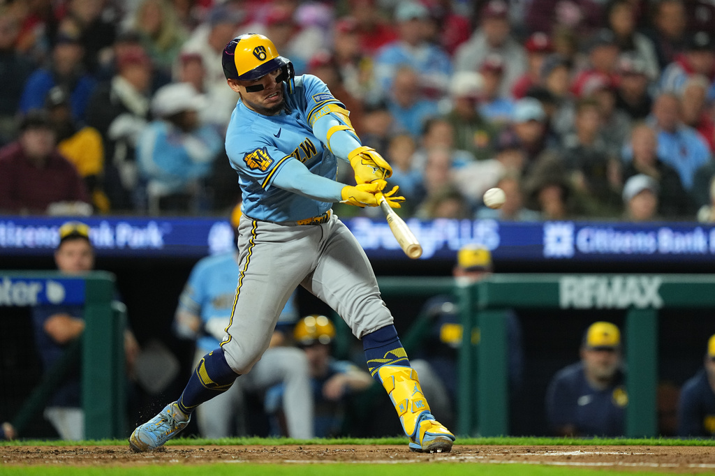 Milwaukee Brewers' William Contreras hits a sacrifice fly off of Philadelphia Phillies pitcher Zack Wheeler during the fourth inning of a baseball game, Tuesday, Sept. 22, 2026, in Philadelphia. (AP Photo/Matt Rourke)