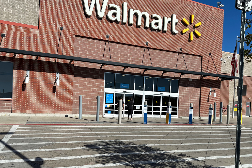 FILE - A shopper heads into a Walmart store Thursday, Oct. 16, 2025, in Englewood, Colo. (AP Photo/David Zalubowski, File)