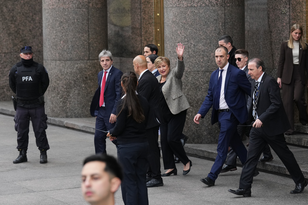President of the International Monetary Fund Kristalina Georgieva waves as she leaves the Economy Ministry after a meeting with Argentina Economy Minister Luis Caputo, left, in Buenos Aires, Argentina, Monday, July 27, 2026. (AP Photo/Gustavo Garello)
