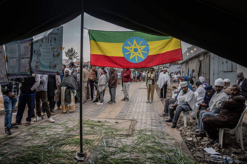 Ethiopian voters gather outside a polling station before voting begins in the general election in Addis Ababa, Ethiopia, Monday, June 1, 2026. (AP Photo/Amanuel Sileshi)