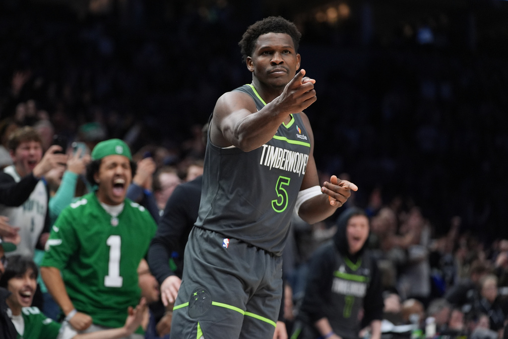 Minnesota Timberwolves guard Anthony Edwards (5) reacts after making a basket during the second half of an NBA basketball game against the San Antonio Spurs, Sunday, Jan. 11, 2026, in Minneapolis. (AP Photo/Abbie Parr)