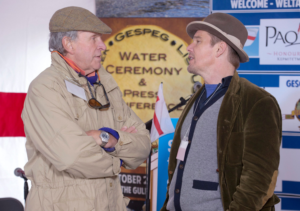 FILE - Actor Ethan Hawke, right, talks with Charles Gaines as they attend the Mi'kmaq community's water ceremony on the shores of Pomquet Harbour to support the aboriginal call for a moratorium on oil and gas exploration in the Gulf of St. Lawrence, near Antigonish, Nova Scotia, on Oct. 26, 2015. (Andrew Vaughan/The Canadian Press via AP)