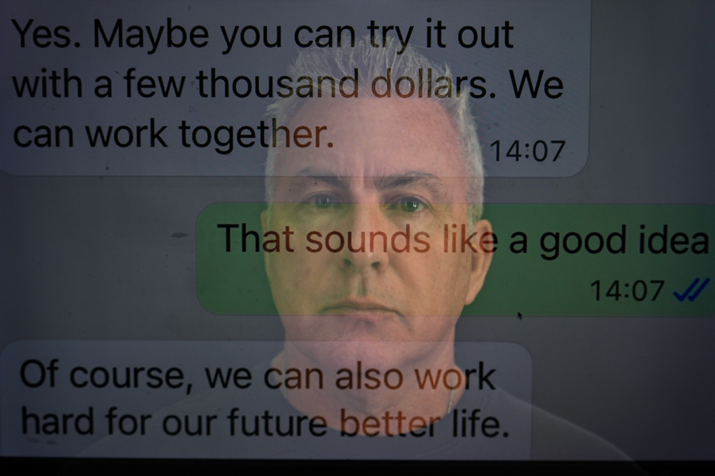 Chris Colocousis sits for a portrait, layered with a screenshot of a text message exchange with a woman he was communicating with who turned out to be a scammer, in this long exposure photograph at his home in Raynham, Mass., Tuesday, March 10, 2026. (AP Photo/David Goldman)