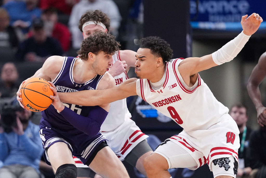 FILE - Northwestern forward Nick Martinelli protects the ball from Wisconsin guard John Tonje (9) during the first half of an NCAA college basketball game in the second round of the Big Ten Conference tournament in Indianapolis, March 13, 2025. (AP Photo/Michael Conroy, File)