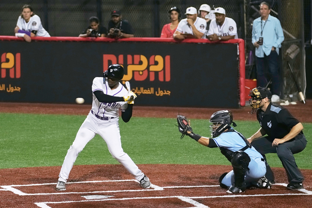 A Mumbai batter hits the ball during the league's opening baseball game against Karachi at the new Barry Larkin Field in Ud al-Bayda on the outskirts of Dubai, United Arab Emirates, Friday, Nov. 14, 2025. (AP Photo/Fatima Shbair)