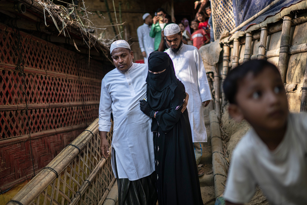 Rohingya refugee bride Mushorofa is escorted by her father to her husband's house on her wedding day in the Rohingya refugee camp in Cox's Bazar, Bangladesh, Friday, Nov. 21, 2025. (AP Photo/Mahmud Hossain Opu)