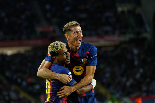 Barcelona's Robert Lewandowski, top, celebrates with Lamine Yamal scoring his side's 2nd goal during a Spanish La Liga soccer match between FC Barcelona and Real Sociedad at the Lluis Companys Olympic Stadium in Barcelona, Spain, Sunday, Sept. 28, 2025. (AP Photo/Joan Monfort) Barcelona's Robert Lewandowski, top, celebrates with Lamine Yamal scoring his side's 2nd goal during a Spanish La Liga soccer match between FC Barcelona and Real Sociedad at the Lluis Companys Olympic Stadium in Barcelona, Spain, Sunday, Sept. 28, 2025. (AP Photo/Joan Monfort)
