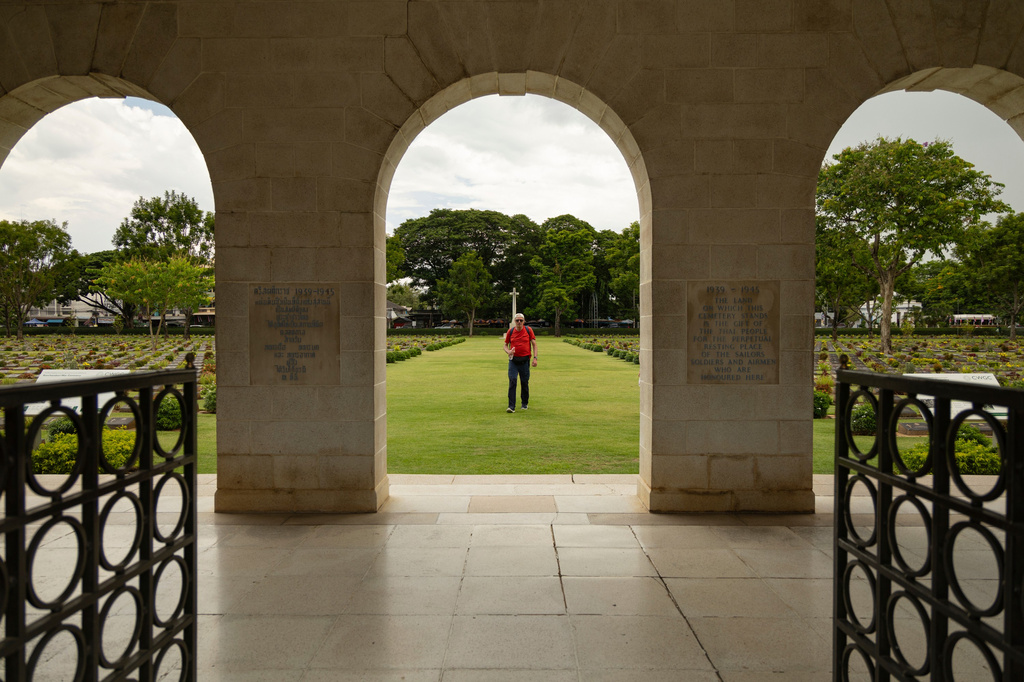A visitor walks through the Don-Rak War Cemetary for the prisoners of war who died building the infamous World War II "Death Railway," in Kanchanaburi, Thailand, Sunday, May 31, 2026. (AP Photo/Anton L. Delgado)