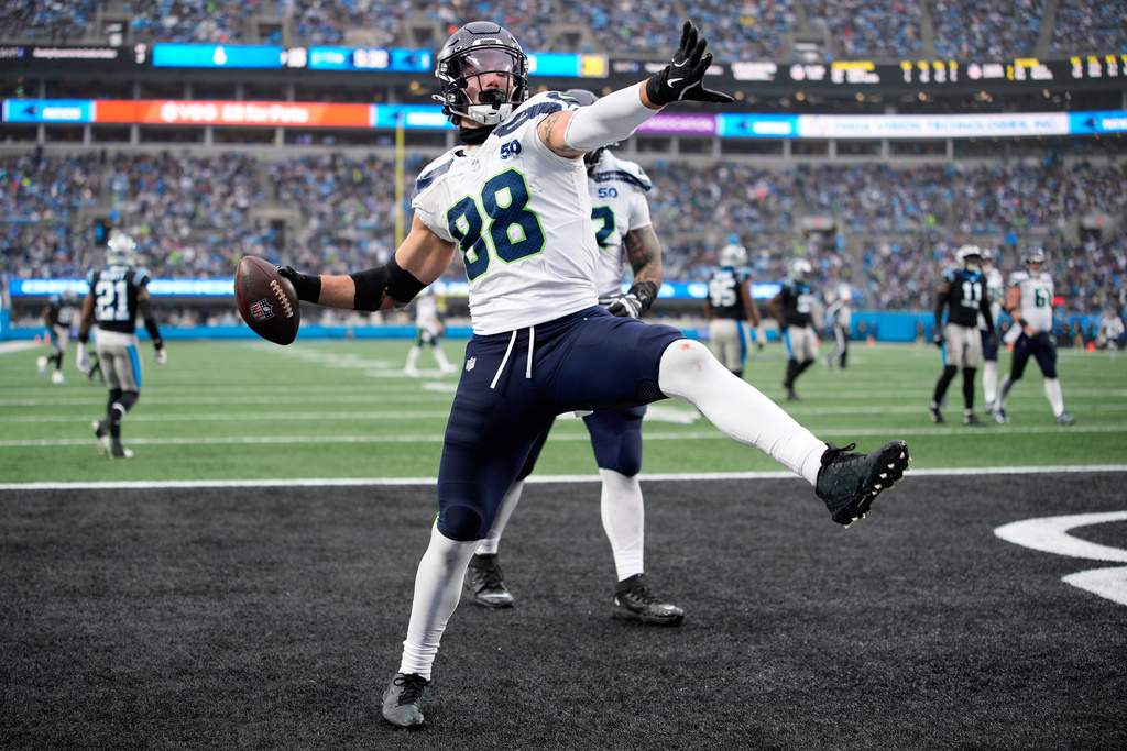 Seattle Seahawks tight end AJ Barner celebrates after scoring against the Carolina Panthers during the second half of an NFL football game, Sunday, Dec. 28, 2025, in Charlotte, N.C. (AP Photo/Jacob Kupferman)