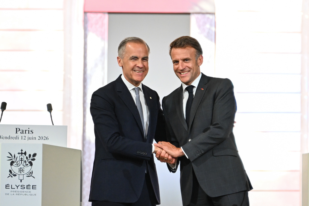 French President Emmanuel Macron, right, and Canada's Prime Minister Mark Carney at the Palais de l'Elysee in Paris, Friday June 12, 2026. (AP Photo/Emma Da Silva, Pool)