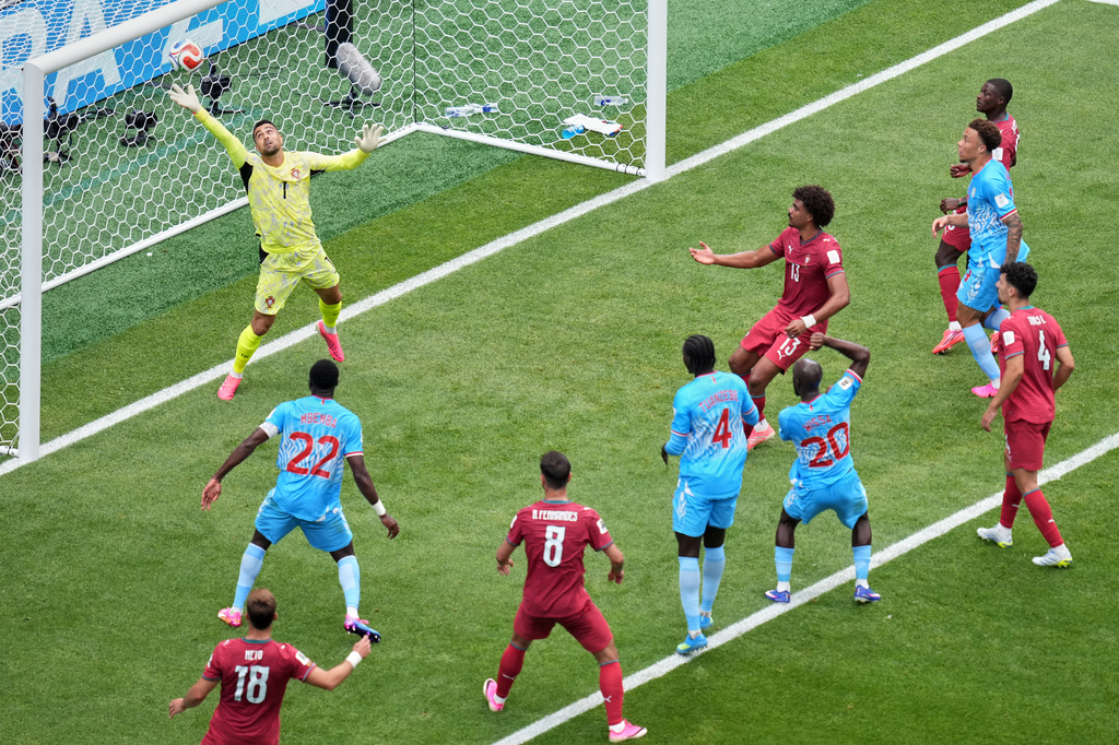 Portugal goalkeeper Diogo Costa (1) fails a headed goal by Congo's Yoane Wissa (20) during the World Cup Group K soccer match between Portugal and Congo in Houston, Wednesday, June 17, 2026. (AP Photo/Eric Smith)