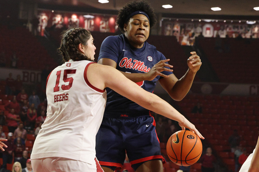 Oklahoma center Raegan Beers (15) knocks the ball away from Mississippi forward Christeen Iwuala, right, during the first half of an NCAA college basketball game Thursday, Jan. 8, 2026, in Norman, Okla. (AP Photo/Nate Billings)