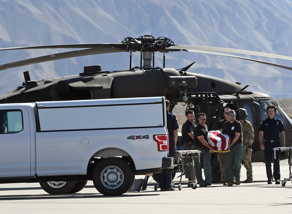 Firefighters carry the flag-draped body of one of the three firefighters killed while fighting the Snyder Fire in Grand Junction, Colo. Sunday, June 28, 2026. (Gretel Daugherty via AP)
